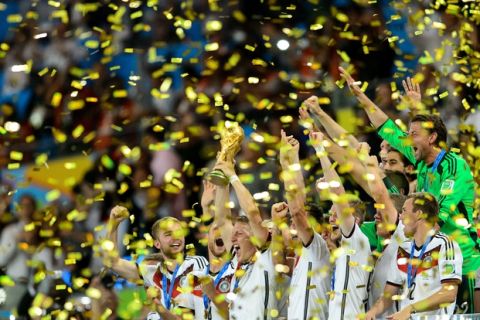 RIO DE JANEIRO, BRAZIL - JULY 13: Germany celebrate with the World Cup trophy after defeating Argentina 1-0 in extra time during the 2014 FIFA World Cup Brazil Final match between Germany and Argentina at Maracana on July 13, 2014 in Rio de Janeiro, Brazil.  (Photo by Matthias Hangst/Getty Images)
