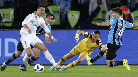 Real Madrid's Cristiano Ronaldo, left, challenges Gremio's Walter Kannemann, right, during the Club World Cup final soccer match between Real Madrid and Gremio at Zayed Sports City stadium in Abu Dhabi, United Arab Emirates, Saturday, Dec. 16, 2017. (AP Photo/Hassan Ammar)