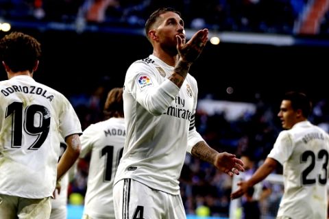 Real Madrid's Sergio Ramos blows a kiss as he celebrates scoring his side's 2nd goal from the penalty spot during a Spanish La Liga soccer match between Real Madrid and Valladolid at the Santiago Bernabeu stadium in Madrid, Spain, Saturday, Nov. 3, 2018. (AP Photo/Paul White)