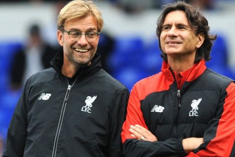 Liverpool manager Juergen Klopp, left, smiles with assistant manager Zeljko Buvac before the English Premier League soccer match between Tottenham Hotspur and Liverpool at the White Hart Lane, London, England, Saturday, Oct. 17, 2015. (AP Photo/Rui Vieira)
