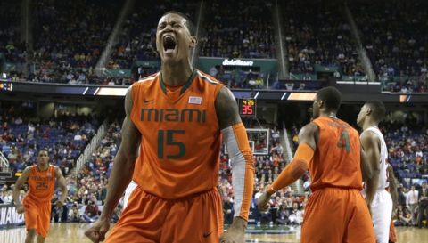 Miami's Rion Brown (15) reacts after dunking against North Carolina State during the first half of a second round NCAA college basketball game at the Atlantic Coast Conference tournament in Greensboro, N.C., Thursday, March 13, 2014. (AP Photo/Gerry Broome)