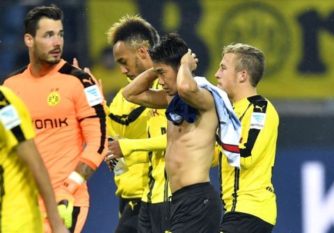 Dortmund's Shinji Kagawa and Pierre-Emerick Aubameyang leave the pitch disappointed after the German Bundesliga soccer match between Borussia Dortmund and Hertha BSC Berlin in Dortmund, Germany, Friday, Oct. 14, 2016. The match ended 1-1. (AP Photo/Martin Meissner)