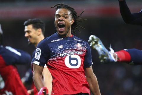 Lille's Loic Remy, center, reacts after scoring during his French League One soccer match between Lille and Lyon at the Lille Metropole stadium in Villeneuve d'Ascq, northern France, Sunday, March 8, 2020. (AP Photo/Michel Spingler)