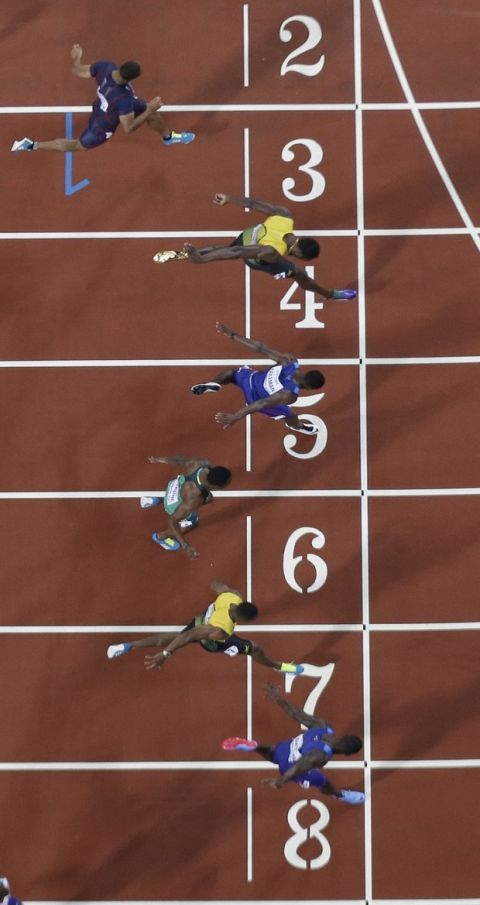 United States' Justin Gatlin, bottom, crosses the line to win the gold medal in the Men's 100m final ahead of United States' Christian Coleman, center, and Jamaica's Usain Bolt, second top, during the World Athletics Championships in London, Saturday, Aug. 5, 2017. (AP Photo/David J. Phillip)