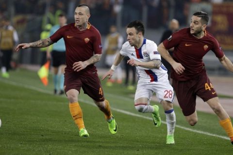 Lyon's Mathieu Valbuena, center, tries to run past Roma's Radja Nainggolan, left, and Roma's Kostas Manolas, right, during the Europa League round of 16 second leg soccer match between Roma and Lyon, in Rome's Olympic stadium, Thursday, March 16, 2017. (AP Photo/Andrew Medichini)