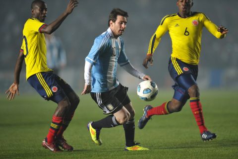 Argentine forward Lionel Messi (C) is marked by Colombian midfielder Carlos Sanchez (R) and forward Adrian Ramos during a 2011 Copa America Group A first round football match held at the Cementerio de Elefantes stadium in Santa Fe, 476 Km north of Buenos Aires, on July 6, 2011.  AFP PHOTO / RODRIGO BUENDIA (Photo credit should read RODRIGO BUENDIA/AFP/Getty Images)