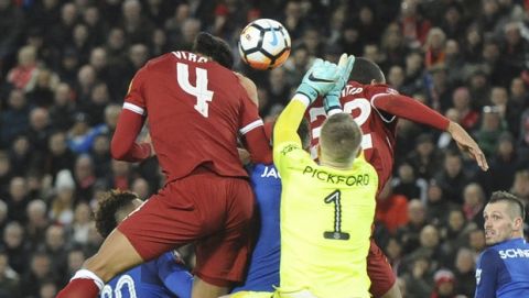 Liverpool's Virgil van Dijk, top left, heads the ball to score his side's second goal during the English FA Cup Third Round soccer match between Liverpool and Everton at Anfield in Liverpool, England, Friday, Jan. 5, 2018. (AP Photo/Rui Vieira)