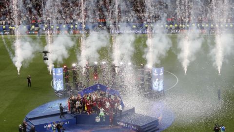 Liverpool players celebrate with the trophy after winning the Champions League Final soccer match between Tottenham Hotspur and Liverpool at the Wanda Metropolitano Stadium in Madrid, Saturday, June 1, 2019. (AP Photo/Armando Franca)