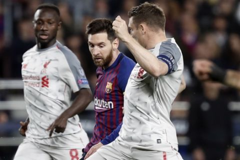 Liverpool's James Milner, center right, tries to block a shot from Barcelona's Lionel Messi, center, during the Champions League semifinal, first leg, soccer match between FC Barcelona and Liverpool at the Camp Nou stadium in Barcelona Spain, Wednesday, May 1, 2019. (AP Photo/Joan Monfort)