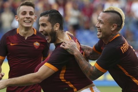 AS Roma's Kostas Manolas (C) celebrates after scoring with teammates Radja Nainggolan (R) and Lucas Digne (L) during their Italian Serie A soccer match against Carpi at the Olympic stadium in Rome, Italy, September 26, 2015. REUTERS/Alessandro Bianchi