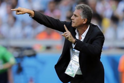 Iran's head coach Carlos Queiroz gives indications to his players from the touchline during the group F World Cup soccer match between Argentina and Iran at the Mineirao Stadium in Belo Horizonte, Brazil, Saturday, June 21, 2014. (AP Photo/Victor R. Caivano)
