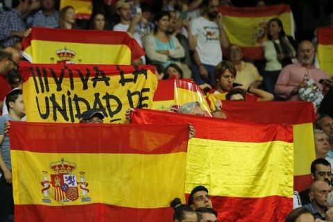 Real Madrid fans display Spanish national flags in support of a united Spain against the Catalonian referendum for independence, during a Spanish La Liga soccer match between Real Madrid and Espanyol at the Santiago Bernabeu stadium in Madrid, Spain, Sunday, Oct. 1, 2017. (AP Photo/Paul White)