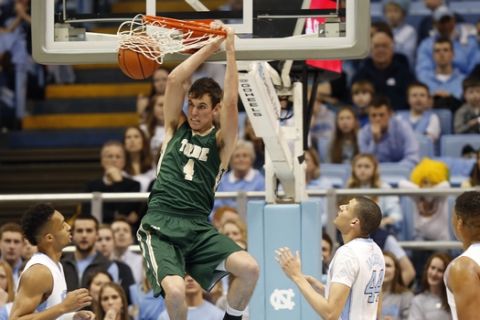 William & Mary's Omar Prewitt (4) dunks against North Carolina's J.P. Tokoto, left, Justin Jackson and Kennedy Meeks (3) during the first half of an NCAA college basketball game Tuesday, Dec. 30, 2014 in Chapel Hill, N.C. (AP Photo/Ellen Ozier)