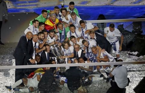 Real Madrid team pose with their trophy for a photograph as they celebrate after winning the Champions League final, at the Santiago Bernabeu stadium in Madrid, Spain, Sunday June 4, 2017. Real Madrid became the first team in the Champions League era to win back-to-back titles with their 4-1 victory over Juventus in Cardiff, Wales, on Saturday. (AP Photo/Francisco Seco)