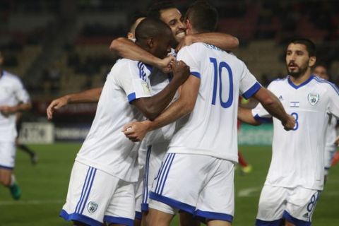 Israels Tomer Hemed, back to the camera, celebrates with his teammates after scoring against Macedonia, during their World Cup Group G qualifying soccer match at the Philip II of Macedon National Stadium in Skopje, Macedonia, on Thursday, Oct. 6, 2016. (AP Photo/Boris Grdanoski)