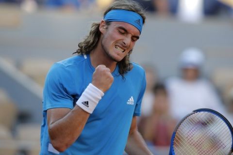 Greece's Stefanos Tsitsipas clenches his fist after scoring a point against Serbia's Filip Krajinovic during their third round match of the French Open tennis tournament at the Roland Garros stadium in Paris, Friday, May 31, 2019. (AP Photo/Michel Euler)