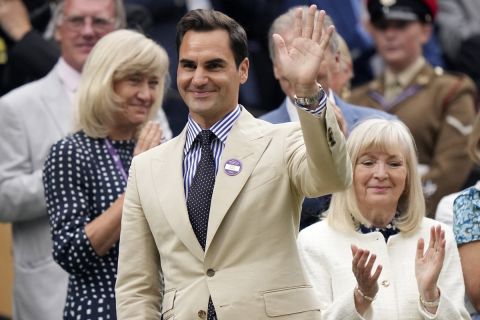 Roger Federer waves from the Royal Box as he is applauded at Centre Court ahead of play on day two of the Wimbledon tennis championships in London, Tuesday, July 4, 2023. Eight-time Wimbledon Champion Roger Federer announced his retirement last year. (AP Photo/Alberto Pezzali)