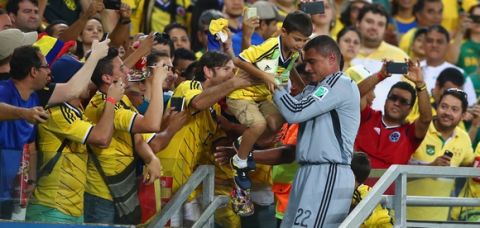 CUIABA, BRAZIL - JUNE 24:  Goalkeeper Faryd Mondragon of Colombia celebrates with his son Lucca after the 2014 FIFA World Cup Brazil Group C match between Japan and Colombia at Arena Pantanal on June 24, 2014 in Cuiaba, Brazil.  (Photo by Mark Kolbe/Getty Images)