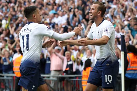 Tottenham Hotspur's Harry Kane, right, celebrates scoring his side's third goal of the game against Fulham, with team-mate Erik Lamela, during their English Premier League soccer match at Wembley Stadium in London, Saturday Aug. 18, 2018. (Nick Potts/PA via AP)