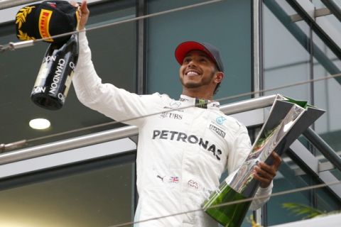 Mercedes driver Lewis Hamilton of Britain acknowledges cheering of spectators before leaving the podium after winning the Chinese Formula One Grand Prix at the Shanghai International Circuit in Shanghai, China, Sunday, April 9, 2017. (AP Photo/Toru Takahashi)