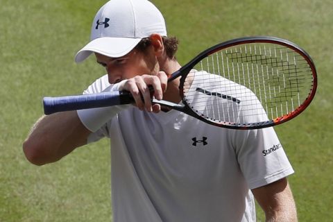 Britain's Andy Murray wipes his face as he plays his Men's Singles Quarterfinal Match against Sam Querrey of the United States on day nine at the Wimbledon Tennis Championships in London Wednesday, July 12, 2017. (AP Photo/Kirsty Wigglesworth)