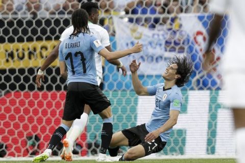 Uruguay's Edinson Cavani, right, falls after missing an opportunity to score against Saudi Arabia during a group A match at the 2018 soccer World Cup in Rostov Arena in Rostov-on-Don, Russia, Wednesday, June 20, 2018. (AP Photo/Andrew Medichini)