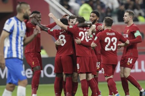 Liverpool's players celebrate after a goal during the Club World Cup semifinal soccer match between Liverpool and Monterrey at the Khalifa International Stadium in Doha, Qatar, Wednesday, Dec. 18, 2019. (AP Photo/Hassan Ammar)