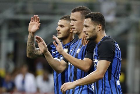 Inter Milan's Ivan Perisic, center, celebrates with his teammates Mauro Icardi, left, and Danilo D'Ambrosio after scoring during the Serie A soccer match between Inter Milan and Fiorentina at the San Siro stadium in Milan, Italy, Sunday, Aug. 20, 2017. (AP Photo/Antonio Calanni)