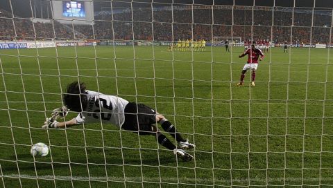 Goalkeeper of Apoel Nicosia Dionisis Chiotis stops the ball from a penalty of Alexandre Lacazette of Lyon during Champions League last sixteen second leg soccer match at GSP stadium in Nicosia, Cyprus, Wednesday, March 7, 2012. (AP Photo/Petros Karadjias)