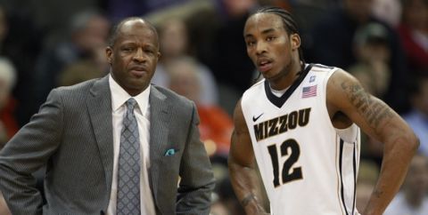 Missouri guard Marcus Denmon (12) talks with coach Mike Anderson during the first half of an NCAA basketball game against Texas Tech in the first round of the Big 12 men's basketball tournament in Kansas City, Mo., Wednesday, March 9, 2011. Missouri defeated Texas Tech 88-84. (AP Photo/Orlin Wagner)