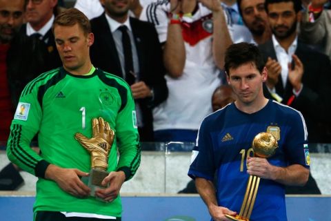 RIO DE JANEIRO, BRAZIL - JULY 13: Manuel Neuer of Germany holds the Golden Glove trophy as Lionel Messi of Argentina holds the Golden Ball trophy during the 2014 FIFA World Cup Brazil Final match between Germany and Argentina at Maracana on July 13, 2014 in Rio de Janeiro, Brazil.  (Photo by Clive Rose/Getty Images)