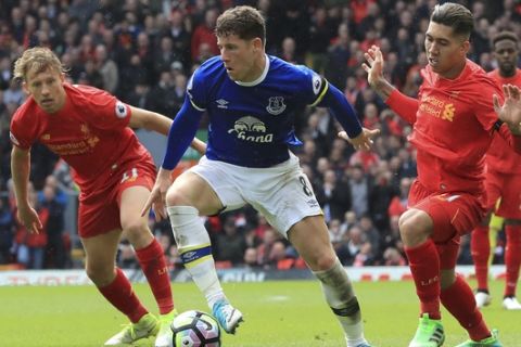 Everton's Ross Barkley, centre, in action with Liverpool's Lucas Leiva, left, and Roberto Firmino during their English Premier League soccer match at Anfield in Liverpool, England, Saturday April 1, 2017. (Peter Byrne/PA via AP)
