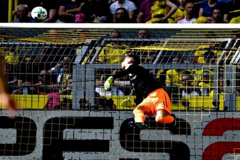 Stuttgart goalkeeper Ron-Robert Zieler receives the opening goal by Dortmund's Christian Pulisic during the German Bundesliga soccer match between Borussia Dortmund and VfB Stuttgart in Dortmund, Germany, Sunday, April 8, 2018. (AP Photo/Martin Meissner)
