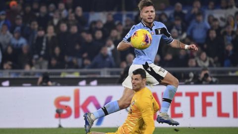 Lazio's Ciro Immobile, top, and Inter Milans goalkeeper Daniele Padelli fight for the ball during the Serie A soccer match between Lazio and inter Milan, at Rome's Olympic stadium, Sunday, Feb. 16, 2020. (Alfredo Falcone/LaPresse via AP)