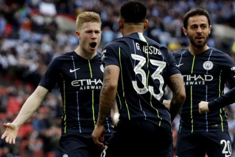 Manchester City's Gabriel Jesus celebrates with his teammates after scoring the opening goal during the English FA Cup semifinal soccer match between Manchester City and Brighton & Hove Albion at Wembley Stadium in London, Saturday, April 6, 2019. (AP Photo/Matt Dunham)