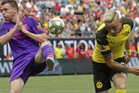 Liverpool's Andrew Robertson, left, blocks a shot by Borussia Dortmund's Marius Wolf during an International Champions Cup tournament soccer match in Charlotte, N.C., Sunday, July 22, 2018. (AP Photo/Chuck Burton)