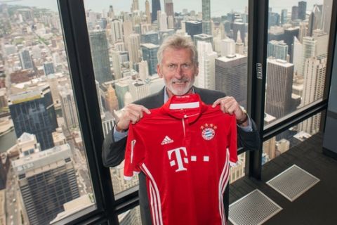 IMAGE DISTRIBUTED FOR INTERNATIONAL CHAMPIONS CUP - Paul Breitner, former Bayern Munich soccer legend, holds up a jersey at the Skydeck of Willis Tower on Friday, May 20, 2016 in Chicago. (Alex Garcia/AP Images for International Champions Cup)
