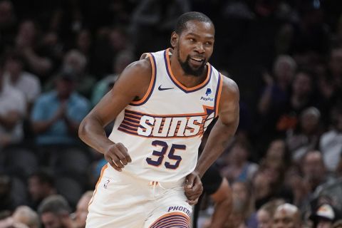 Phoenix Suns' Kevin Durant (35) smiles after making a 3-point basket against the Portland Trail Blazers during the first half of a preseason NBA basketball game, Monday, Oct. 16, 2023, in Phoenix. (AP Photo/Darryl Webb)