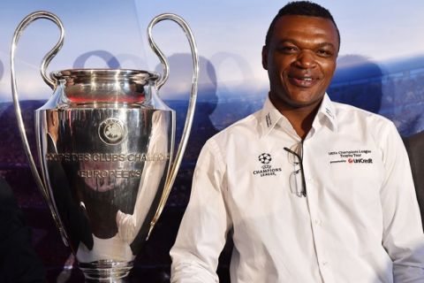 Retired footballer of the French national team that won the 1998 World Cup and Euro 2000 Marcel Desailly poses for photographs next to the trophy of the 2016/17 UEFA Champions League during its presentation in Budapest, Hungary, Friday, Oct. 28, 2016. The final match of the tournament of European soccer teams will take place on June 3, 2017 in the National Stadium of Wales in Cardiff. (Tibor Illyes/MTI via AP)