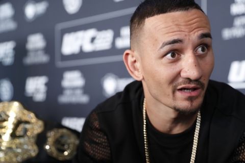 UFC featherweight champion Max Holloway responds to reporters' questions during a media event, Thursday, April 5, 2018, in New York ahead of his Mixed Martial Arts lightweight title fight against Max Nurmamogedov on Saturday. (AP Photo/Kathy Willens)