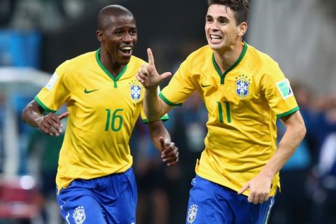 SAO PAULO, BRAZIL - JUNE 12:  Oscar of Brazil (R) celebrates his second half goal with Ramires during the 2014 FIFA World Cup Brazil Group A match between Brazil and Croatia at Arena de Sao Paulo on June 12, 2014 in Sao Paulo, Brazil.  (Photo by Adam Pretty/Getty Images)