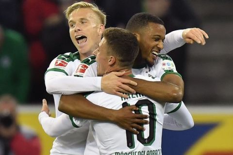Moenchengladbach's Thorgan Hazard is celebrated after scoring his side's third goal during the German Bundesliga soccer match between Borussia Moenchengladbach and FSV Mainz 05 in Moenchengladbach, Germany, Sunday, Oct. 21, 2018. (AP Photo/Martin Meissner)