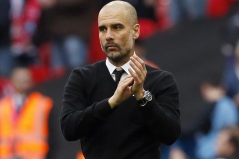 Manchester City manager Pep Guardiola applauds at the end of the English FA Cup semifinal soccer match between Arsenal and Manchester City at Wembley stadium in London, Sunday, April 23, 2017. Arsenal won 2-1. (AP Photo/Kirsty Wigglesworth)