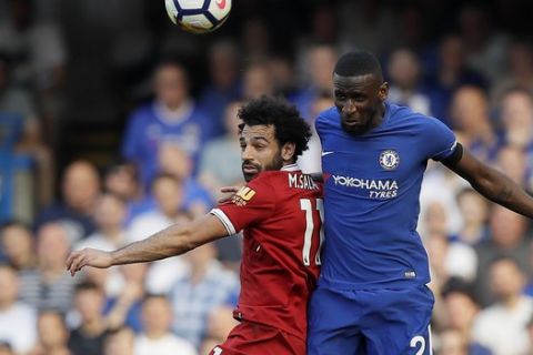 Liverpool's Mohamed Salah, left, jumps for the ball with Chelsea's Antonio Ruediger during the English Premier League soccer match between Chelsea and Liverpool at Stamford Bridge stadium in London, Sunday, May 6, 2018. (AP Photo/Kirsty Wigglesworth)