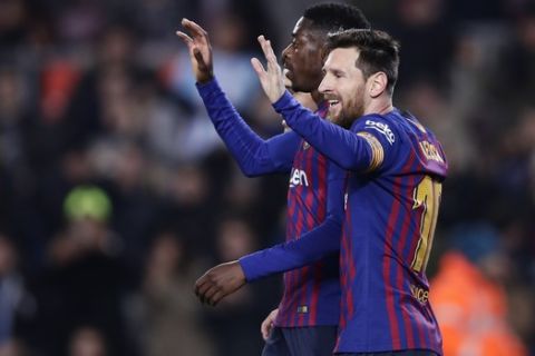 FC Barcelona's Dembele, left, celebrates with his teammate Lionel Messi after scoring his side's second goal during a Spanish Copa del Rey soccer match between FC Barcelona and Levante at the Camp Nou stadium in Barcelona, Spain, Thursday, Jan. 17, 2019. (AP Photo/Manu Fernandez)