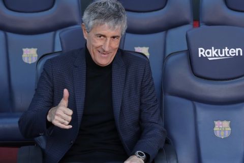 Quique Setien poses on the bench after being officially introduced as the new soccer coach of FC Barcelona at the Camp Nou stadium in Barcelona, Spain, Tuesday, Jan. 14, 2020. Barcelona made a rare coaching change midway through the season, replacing Ernesto Valverde with former Real Betis manager Quique Setien on Monday. (AP Photo/Emilio Morenatti)