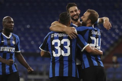 Inter Milan's Christian Eriksen, right, celebrates with teammates after scoring his sides second goal of the game during the Europa League round of 16 soccer match between Inter Milan and Getafe at the Veltins-Arena in Gelsenkirchen, Germany, Wednesday, Aug. 5, 2020. (Lars Baron, Pool Photo via AP)