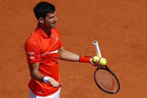 Serbia's Novak Djokovic reacts as he playts against Austria's Dominic Thiem during the men's semifinal match of the French Open tennis tournament at the Roland Garros stadium in Paris, Saturday, June 8, 2019. (AP Photo/Pavel Golovkin)