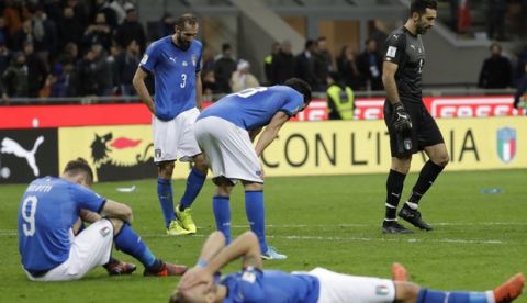 Italian players react to their elimination at the end of the World Cup qualifying play-off second leg soccer match between Italy and Sweden, at the Milan San Siro stadium, Italy, Monday, Nov. 13, 2017. (AP Photo/Luca Bruno)