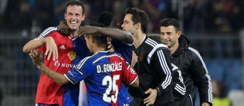 Basel's forward Marco Streller (L) is congratulated by teammates after scoring a goal during the Champions League football match between FC Basel and FC Liverpool on October 1, 2014 at the St. Jakob-Park stadium in Basel.  AFP PHOTO / FABRICE COFFRINI        (Photo credit should read FABRICE COFFRINI/AFP/Getty Images)